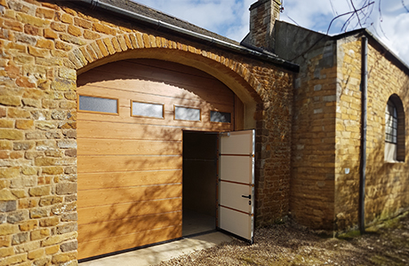 Sectional door with wicket pedestrian door built in